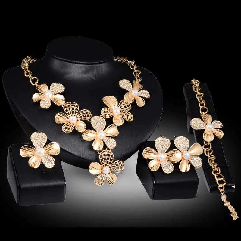 Gold alloy four-piece jewelry set with necklace, earrings, and bracelet in 18K gold finish, artificial gem details