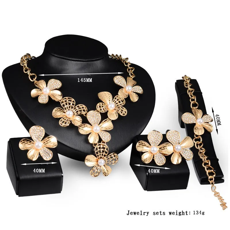 Gold alloy four-piece jewelry set with necklace, earrings, and bracelet in 18K gold finish, artificial gem details