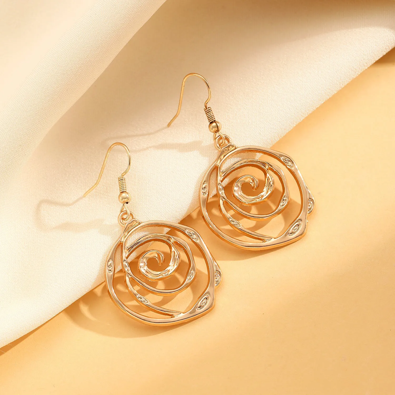Spiral donut jewellery set showing necklace, bracelet, and ear hooks in gold or silver tone alloy