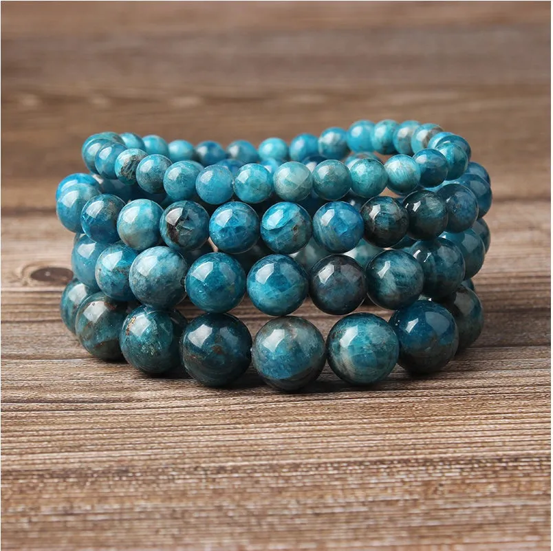 Natural blue apatite elastic beaded bracelet with polished round beads, unisex design, shown on a neutral background