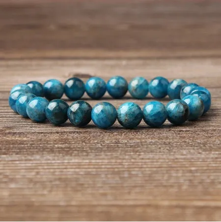 Natural blue apatite elastic beaded bracelet with polished round beads, unisex design, shown on a neutral background