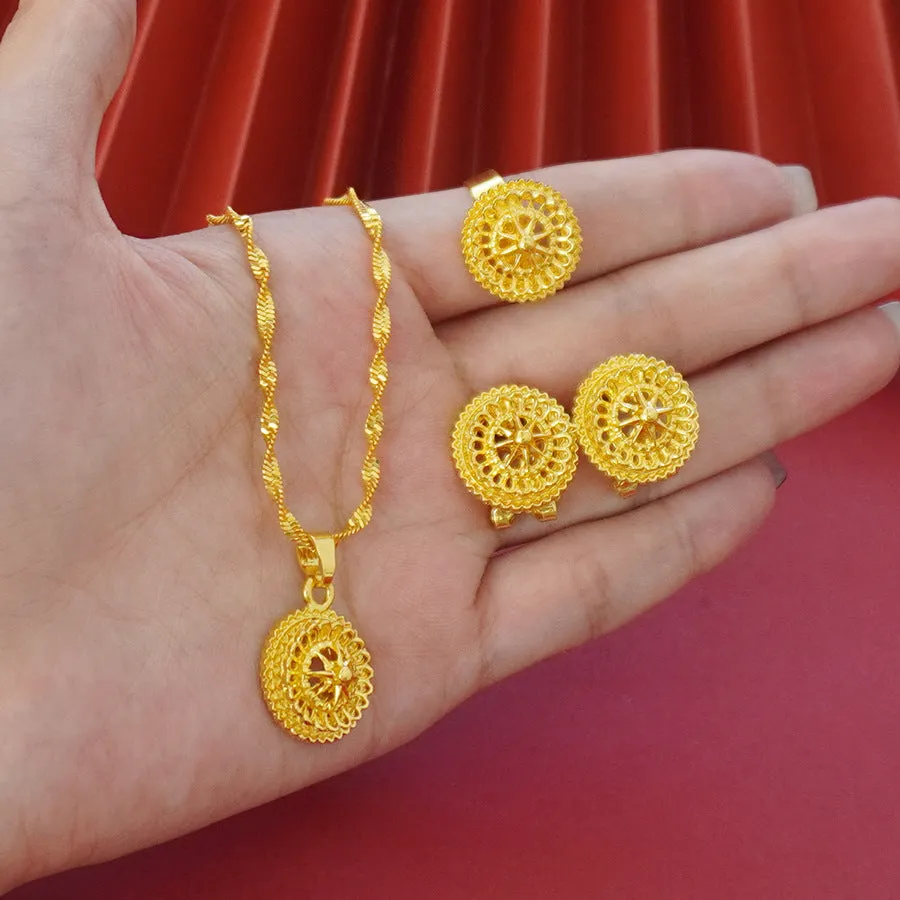 Gold-plated three-piece jewellery set with floral designs showing necklace, earrings, and ring