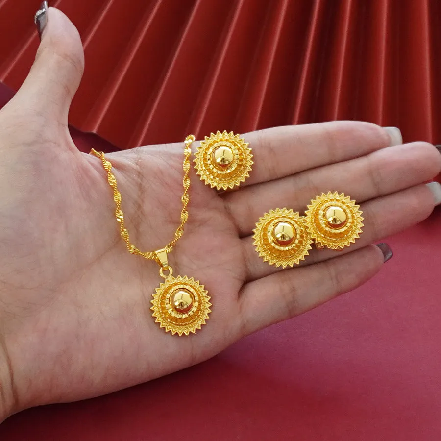 Gold-plated three-piece jewellery set with floral designs showing necklace, earrings, and ring