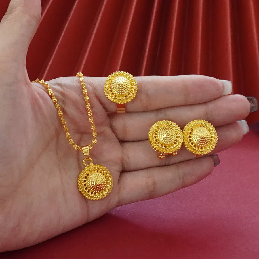Gold-plated three-piece jewellery set with floral designs showing necklace, earrings, and ring