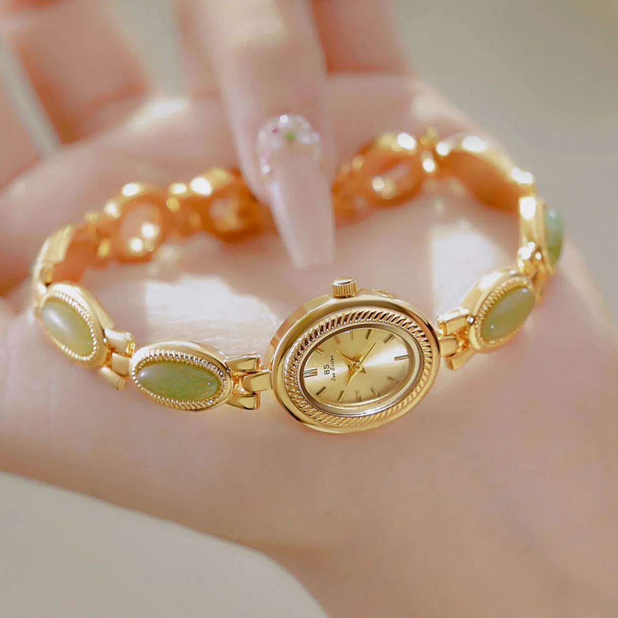 Women's bracelet watch with oval alloy case, natural stone inlay, and mineral glass dial.