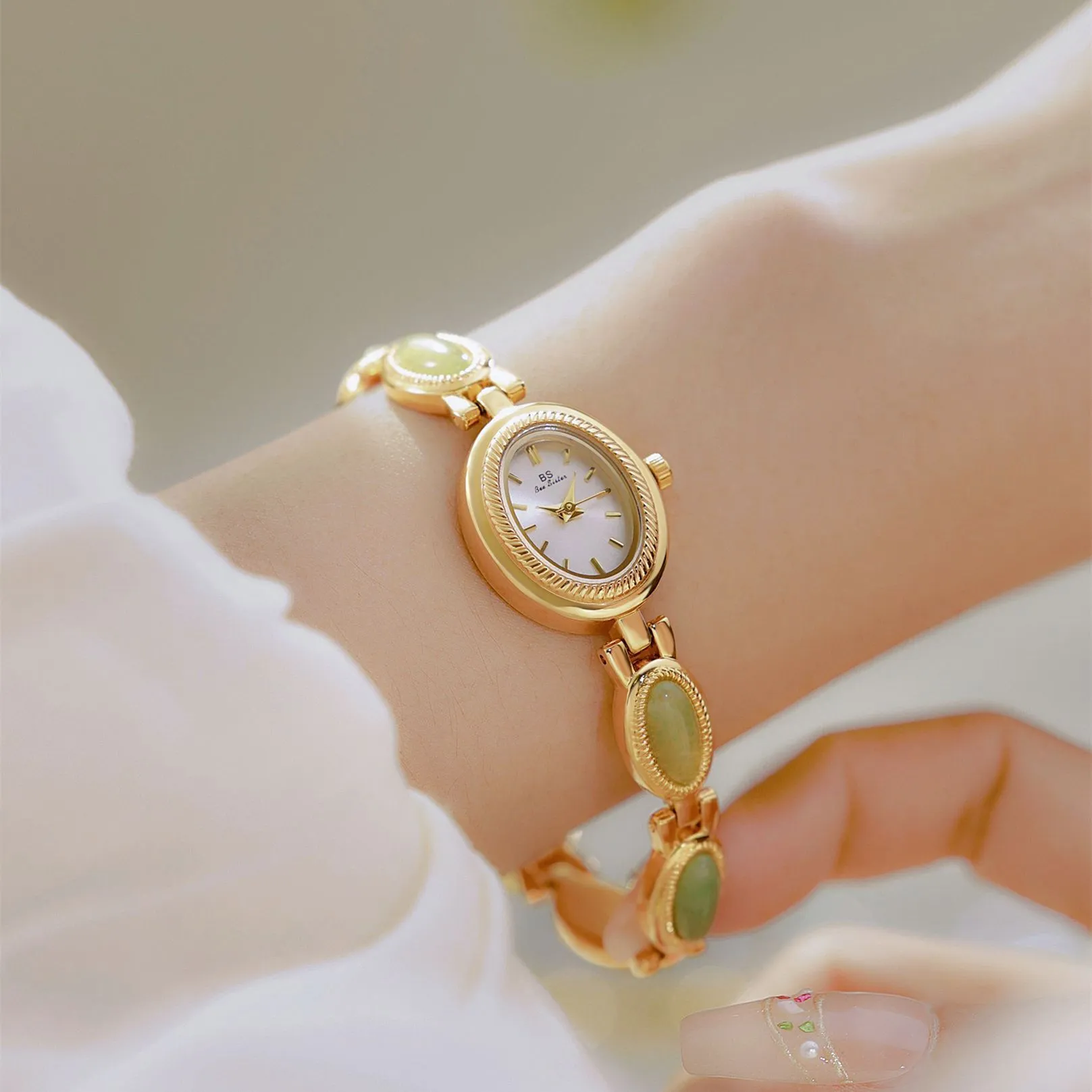 Women's bracelet watch with oval alloy case, natural stone inlay, and mineral glass dial.