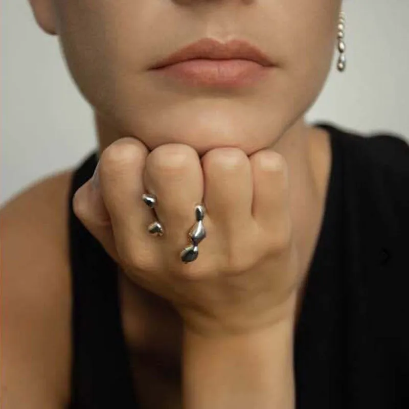Adjustable brass ring with sphere design in gold or silver plating.