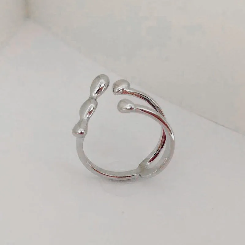 Adjustable brass ring with sphere design in gold or silver plating.