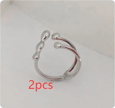 Adjustable brass ring with sphere design in gold or silver plating.