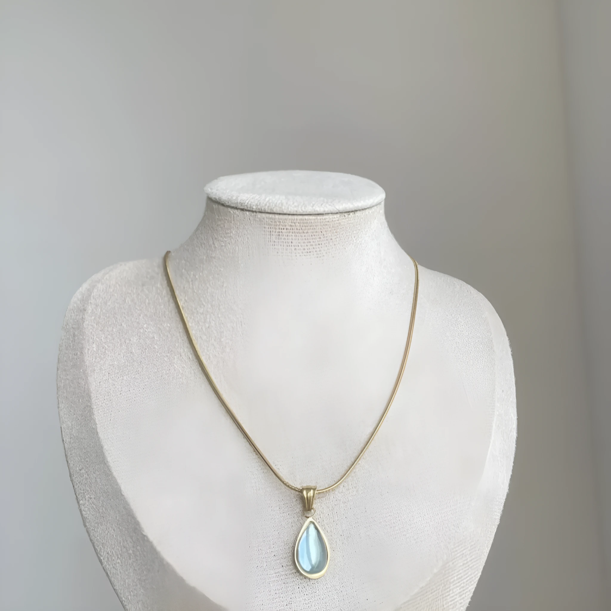Retro water drop necklace for women with blue gemstone pendant on titanium steel snake bone chain.