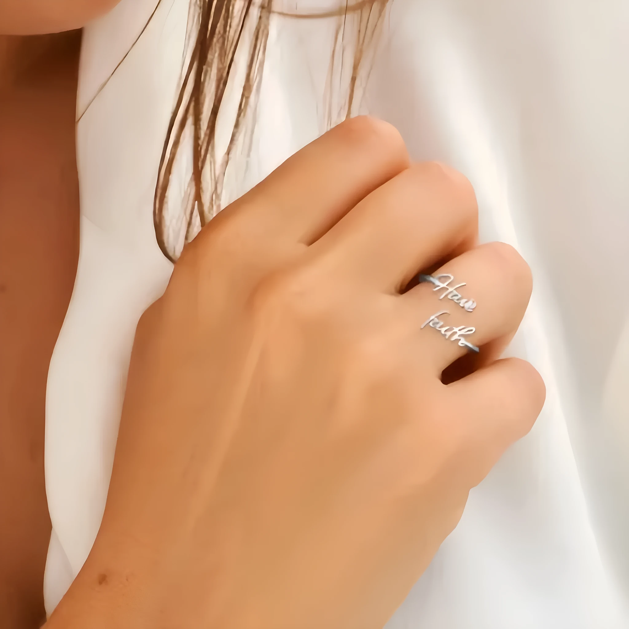 Stainless steel ring in steel colour, one-size adjustable band on a plain background