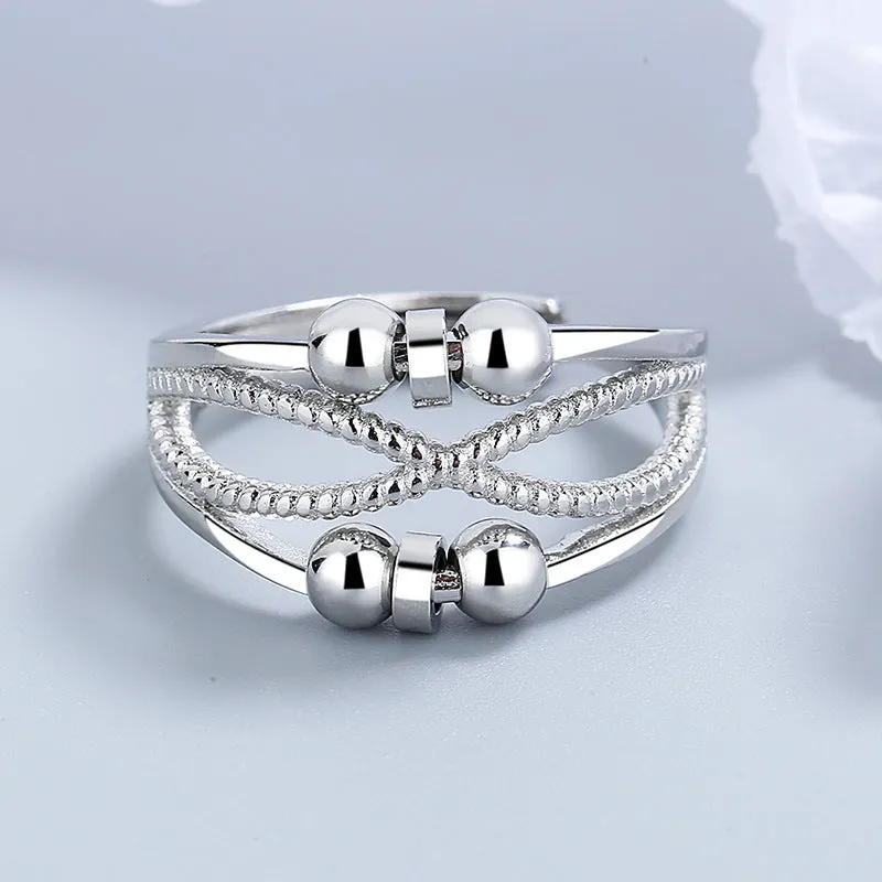 Rotatable copper ring with open design double-layered hollow line construction in platinum colour geometric shape