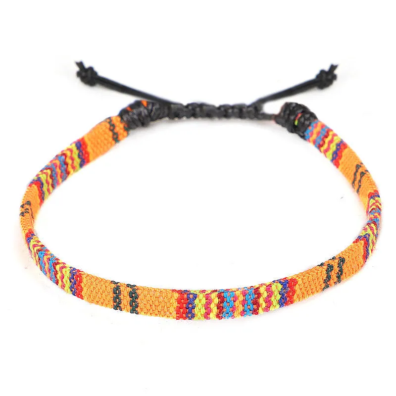Hand woven rainbow colour bohemian style cloth anklet on a neutral background