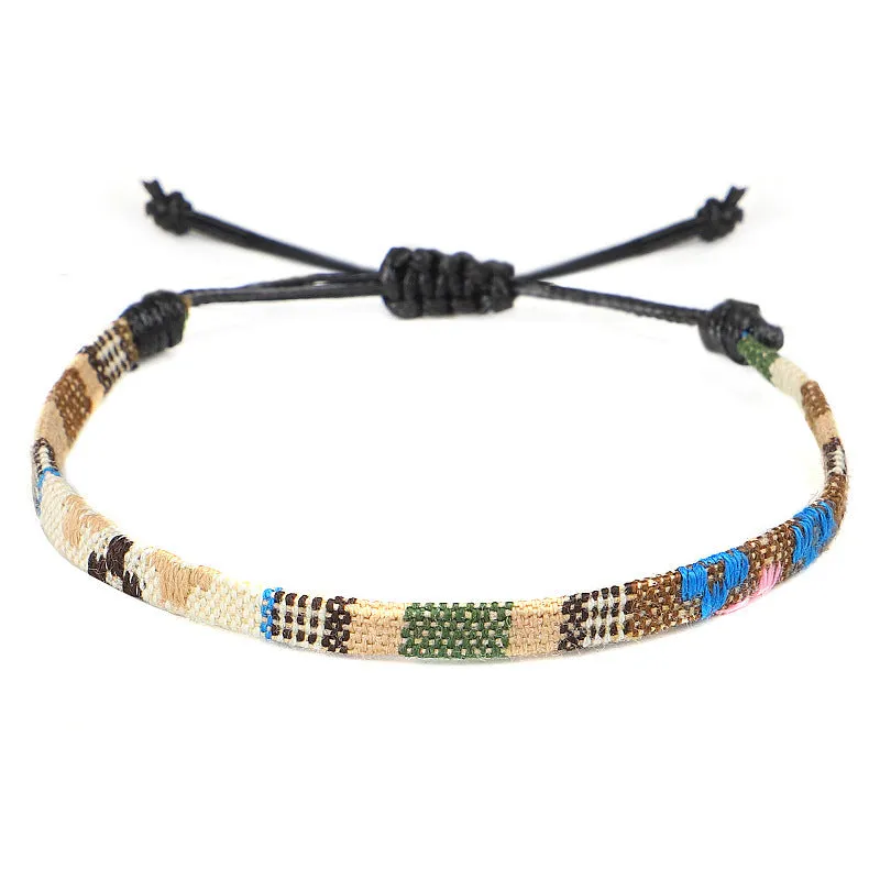 Hand woven rainbow colour bohemian style cloth anklet on a neutral background