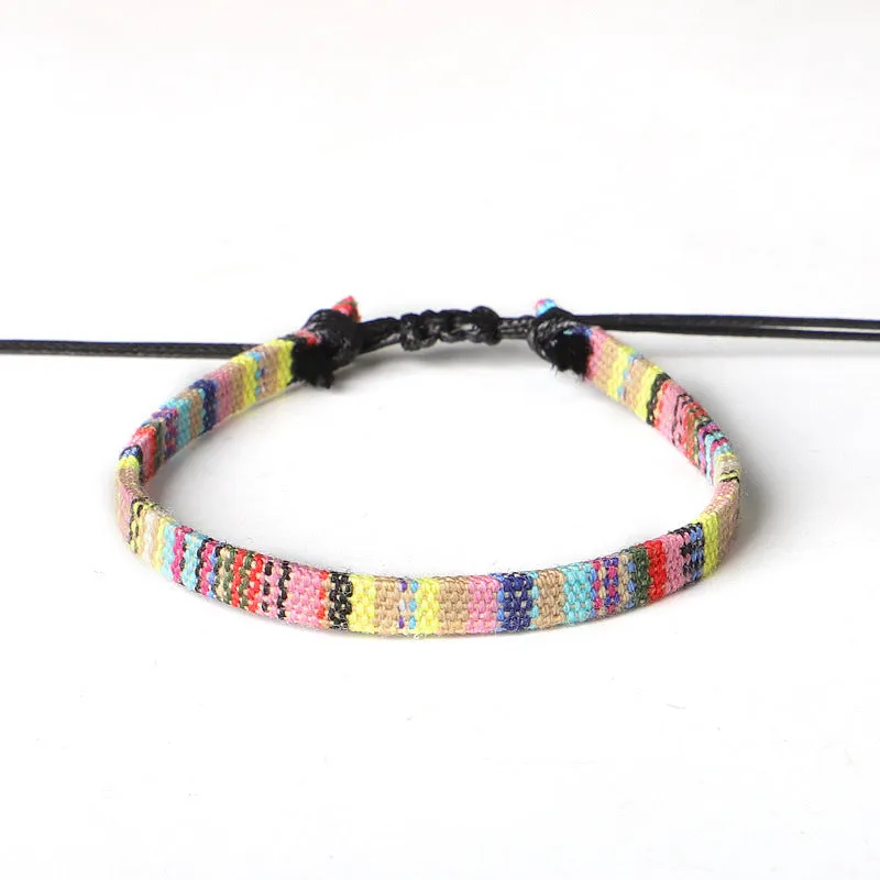 Hand woven rainbow colour bohemian style cloth anklet on a neutral background