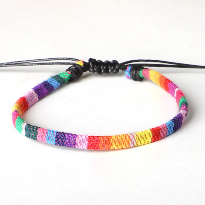 Hand woven rainbow colour bohemian style cloth anklet on a neutral background