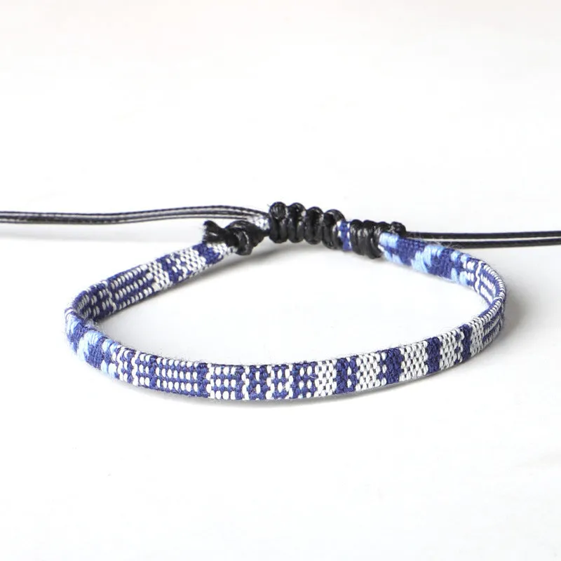 Hand woven rainbow colour bohemian style cloth anklet on a neutral background