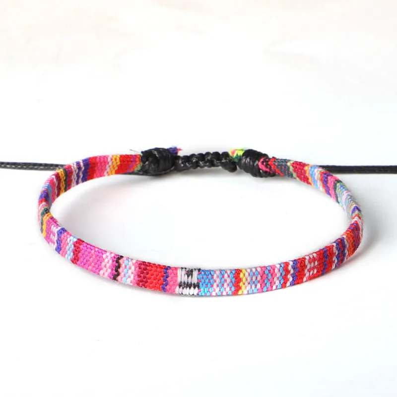 Hand woven rainbow colour bohemian style cloth anklet on a neutral background