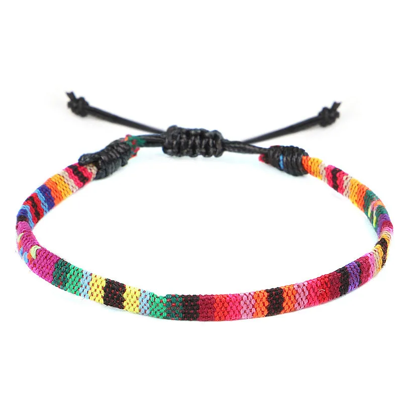 Hand woven rainbow colour bohemian style cloth anklet on a neutral background