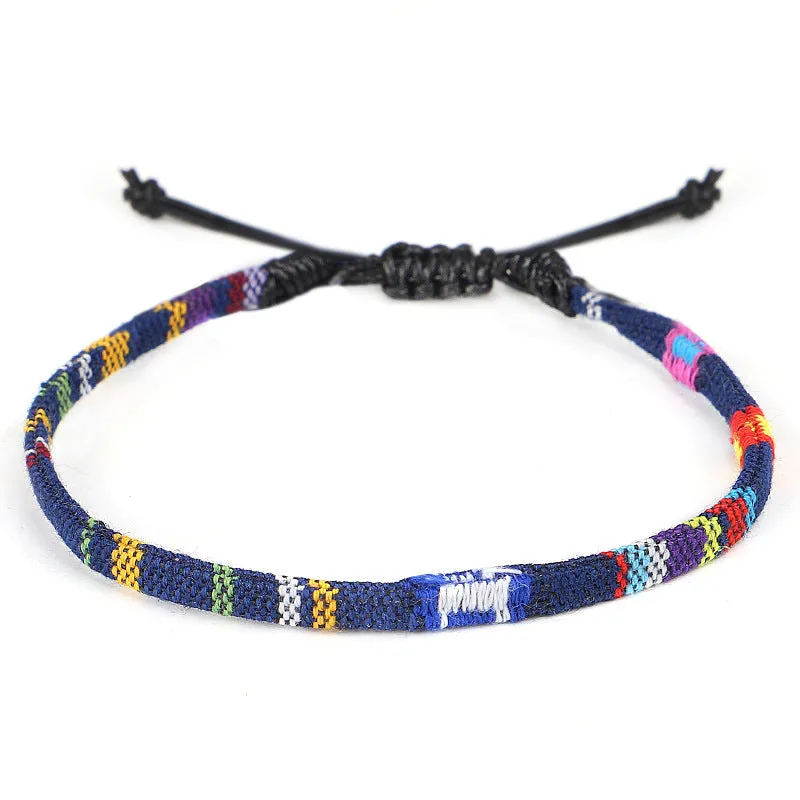 Hand woven rainbow colour bohemian style cloth anklet on a neutral background
