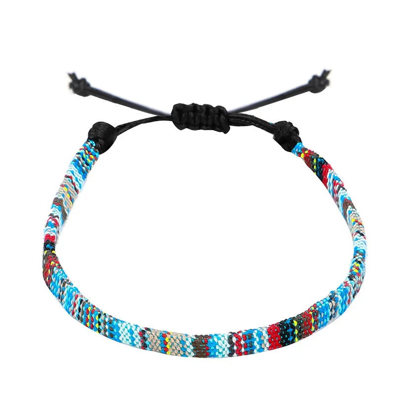 Hand woven rainbow colour bohemian style cloth anklet on a neutral background