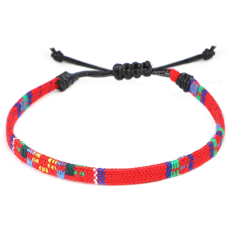 Hand woven rainbow colour bohemian style cloth anklet on a neutral background