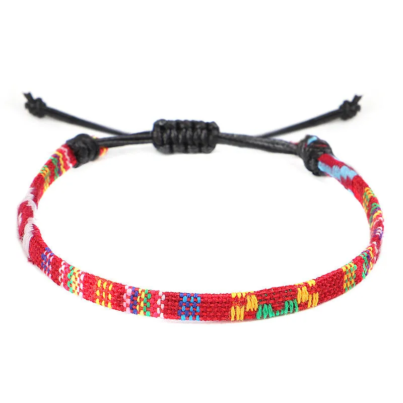Hand woven rainbow colour bohemian style cloth anklet on a neutral background
