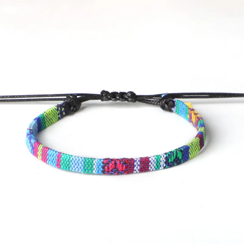 Hand woven rainbow colour bohemian style cloth anklet on a neutral background