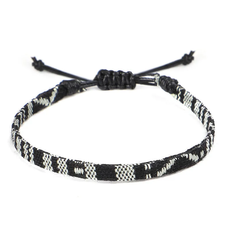 Hand woven rainbow colour bohemian style cloth anklet on a neutral background
