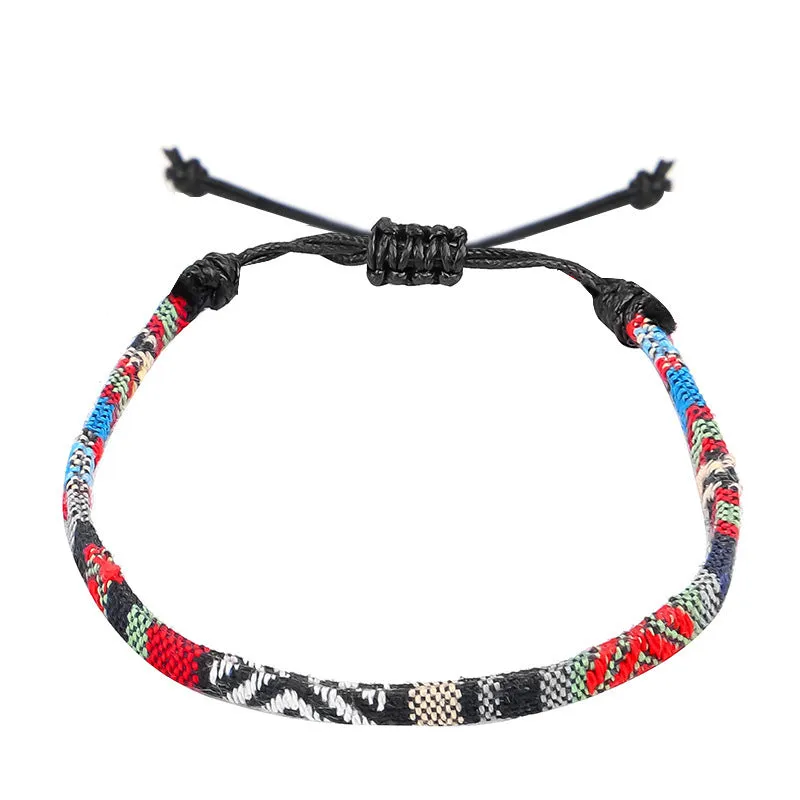 Hand woven rainbow colour bohemian style cloth anklet on a neutral background