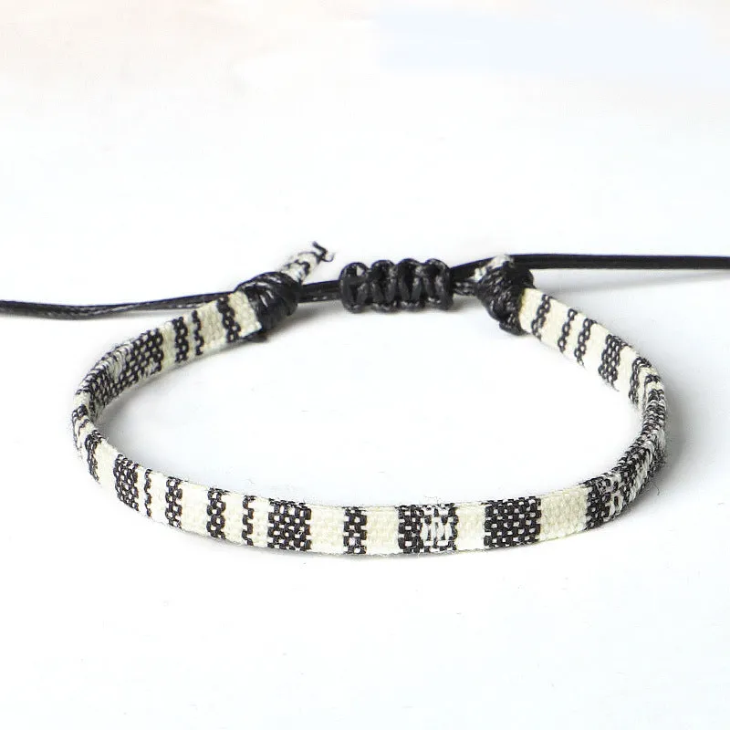Hand woven rainbow colour bohemian style cloth anklet on a neutral background