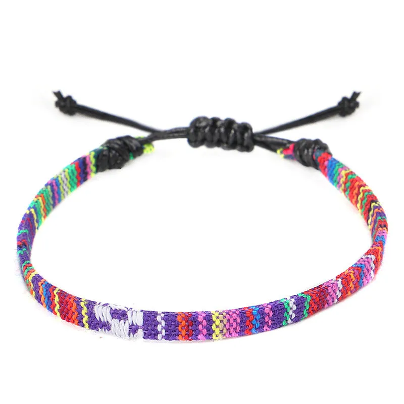 Hand woven rainbow colour bohemian style cloth anklet on a neutral background