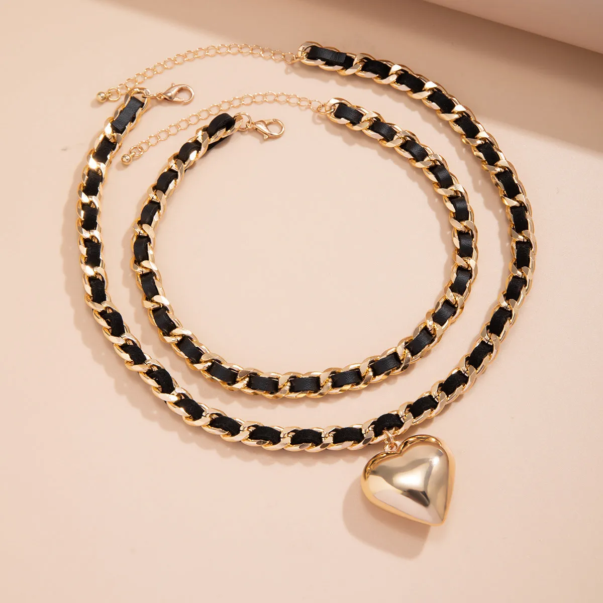 Big Love double-layer chain necklace with heart pendant in gold finish on woman