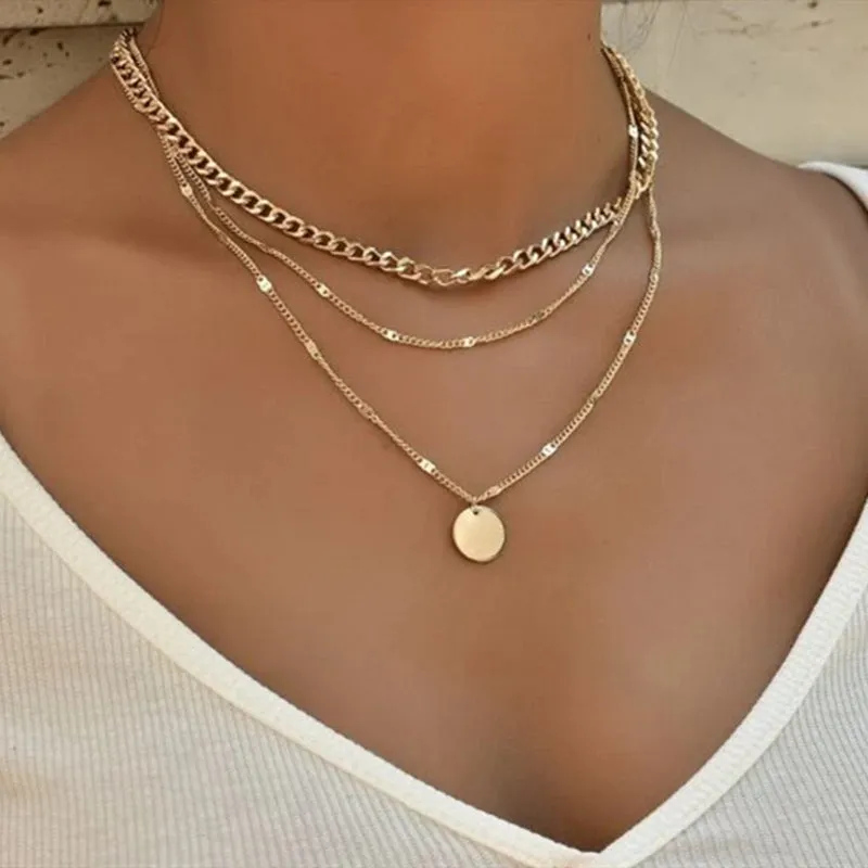 Women's multilayer disc pendant clavicle necklace in gold and silver colour finish on a light background