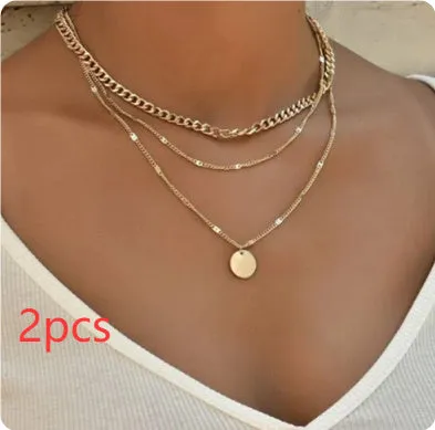 Women's multilayer disc pendant clavicle necklace in gold and silver colour finish on a light background