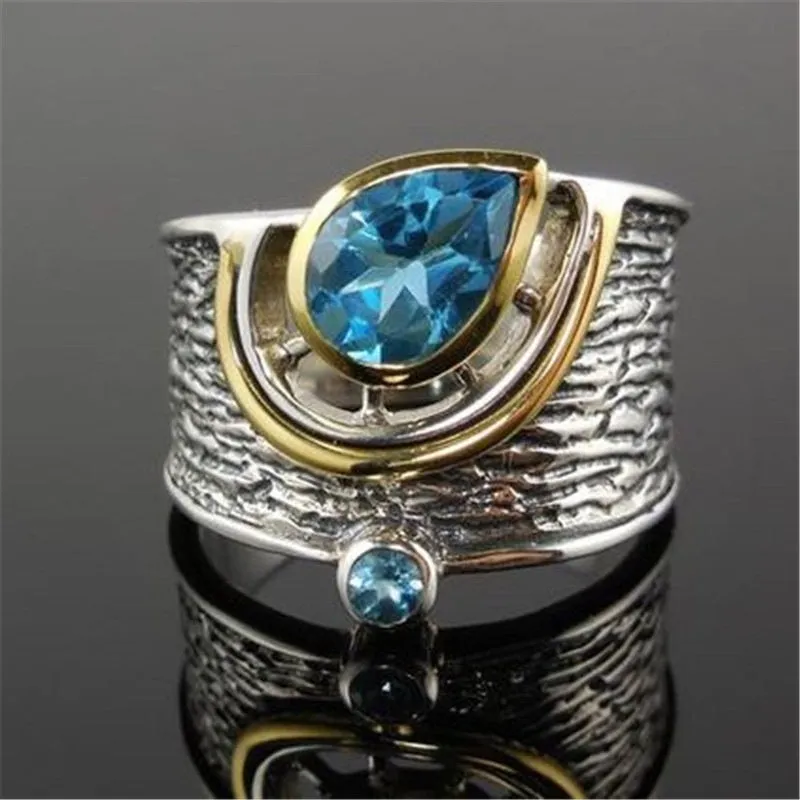 Close-up of a women's blue zircon rhinestone ring in a creative Chinese style drop shape design.
