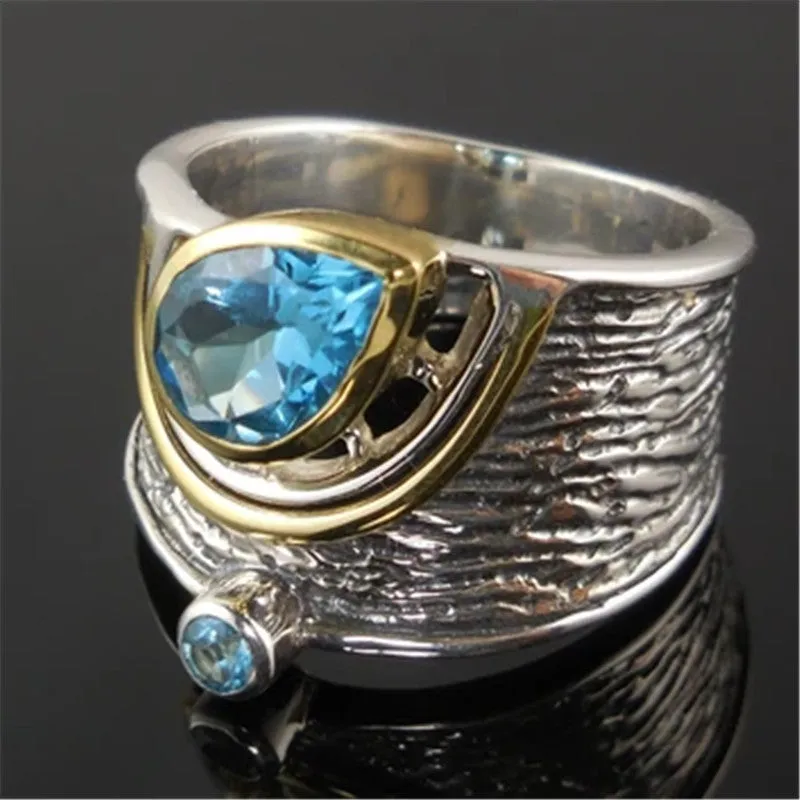 Close-up of a women's blue zircon rhinestone ring in a creative Chinese style drop shape design.