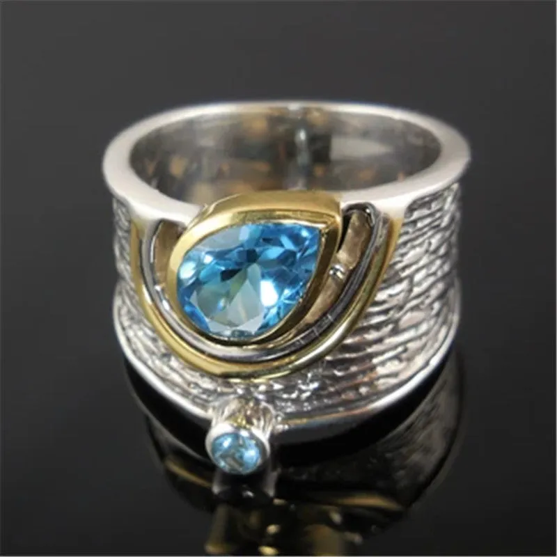 Close-up of a women's blue zircon rhinestone ring in a creative Chinese style drop shape design.
