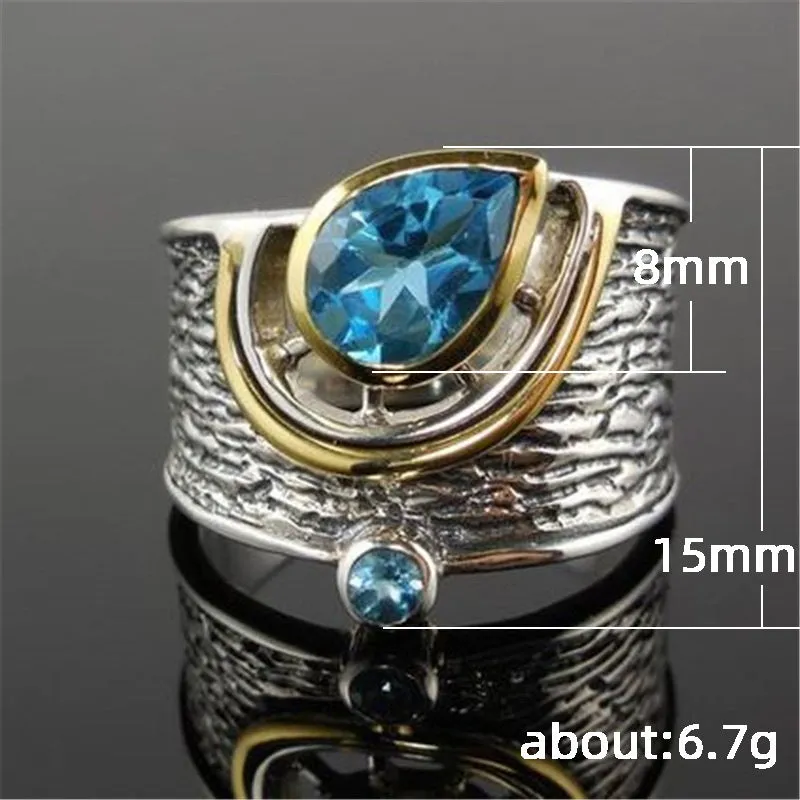 Close-up of a women's blue zircon rhinestone ring in a creative Chinese style drop shape design.
