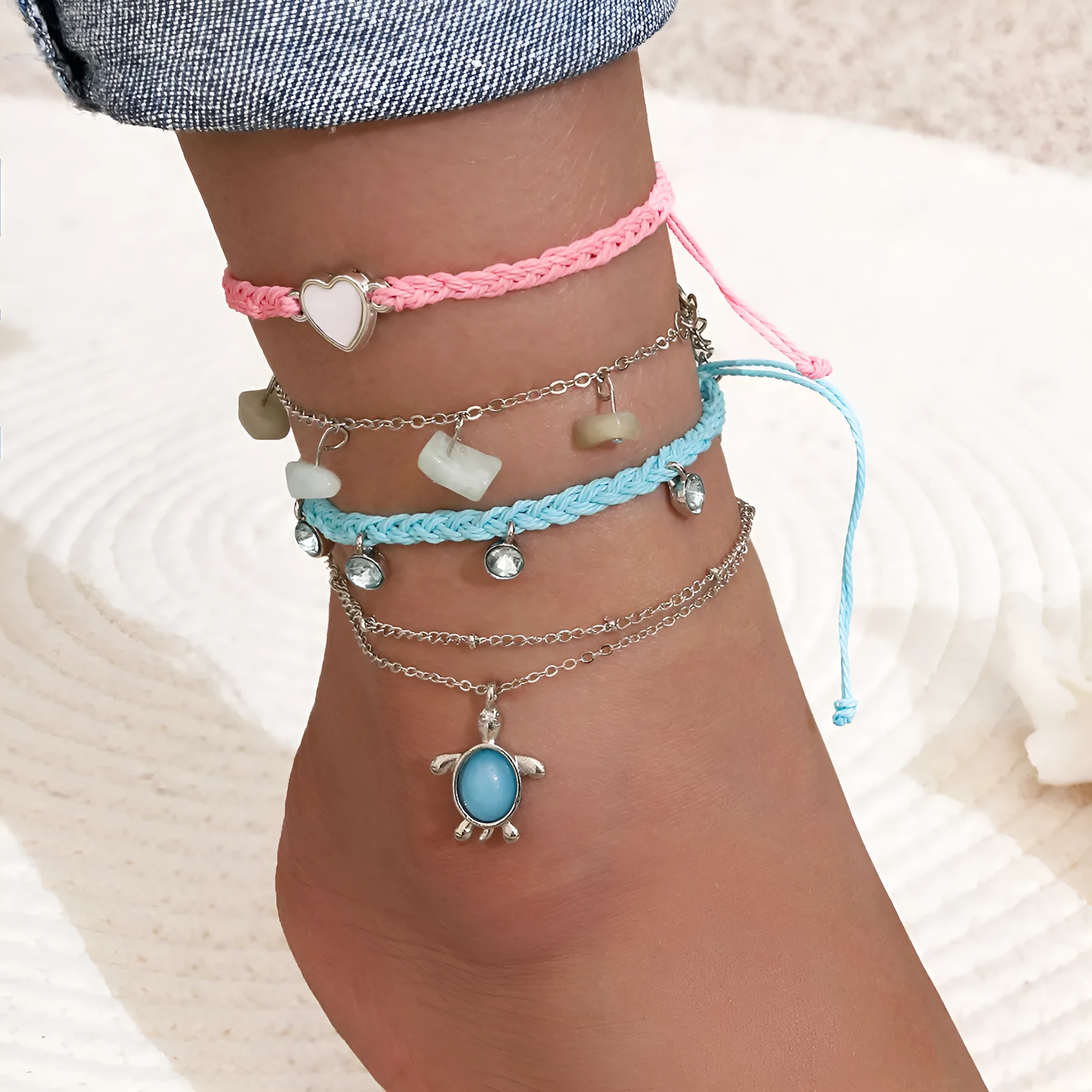 Hand-woven blue love foot rope natural gravel anklet in alloy with geometric shape on a woman's ankle