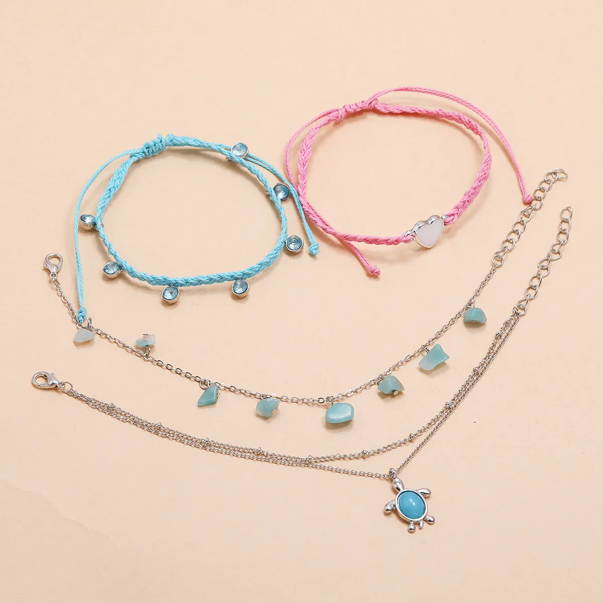 Hand-woven blue love foot rope natural gravel anklet in alloy with geometric shape on a woman's ankle