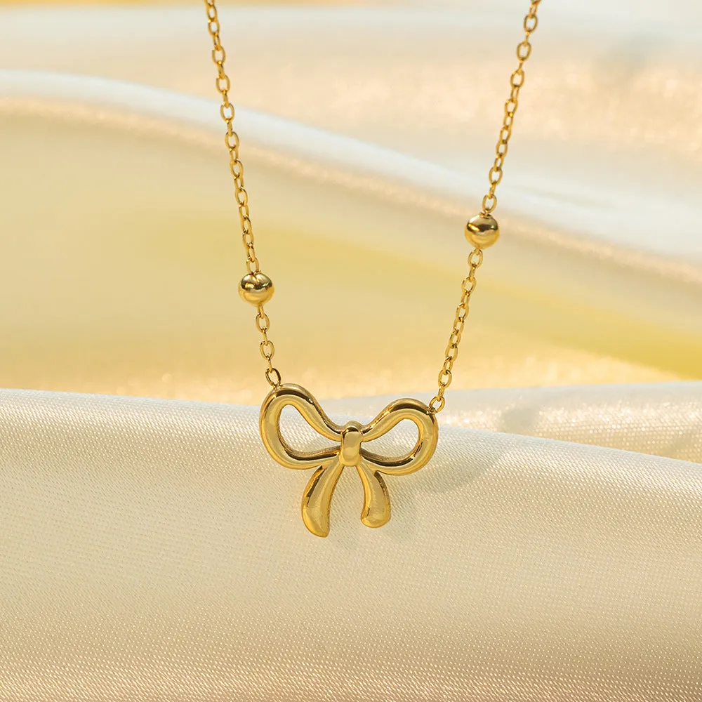 Gold electroplated bow necklace with cross chain design on adjustable 41-50cm chain