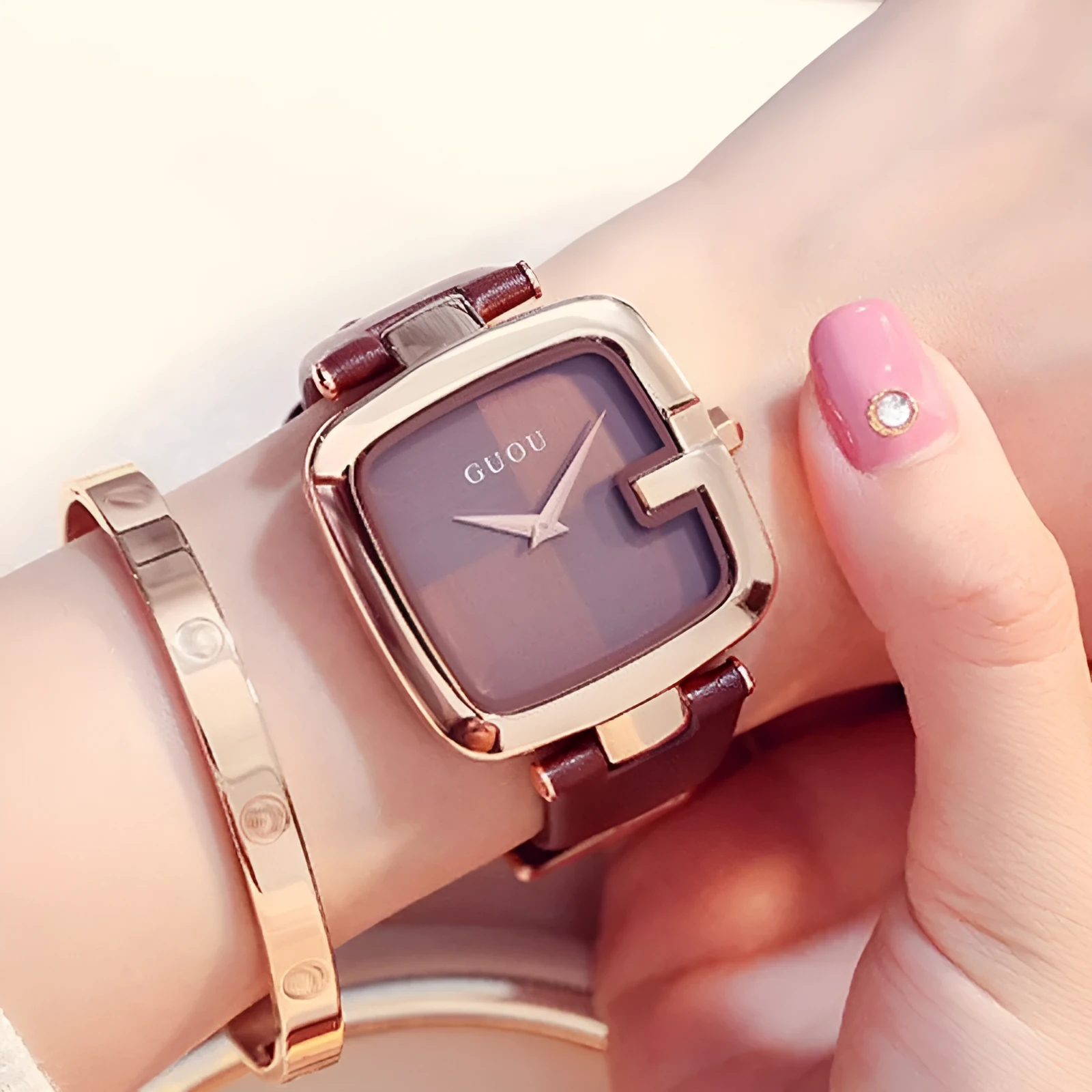 Square quartz watch with 36mm dial, leather strap, rose gold buckle, and mineral glass