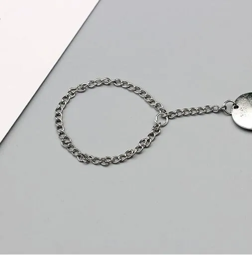 Antique silver hollow flower chain anklet with teardrop shape on a surface, 24cm foot jewellery for women