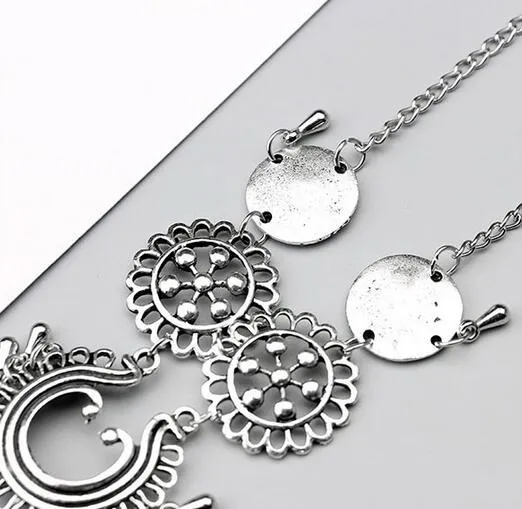 Antique silver hollow flower chain anklet with teardrop shape on a surface, 24cm foot jewellery for women