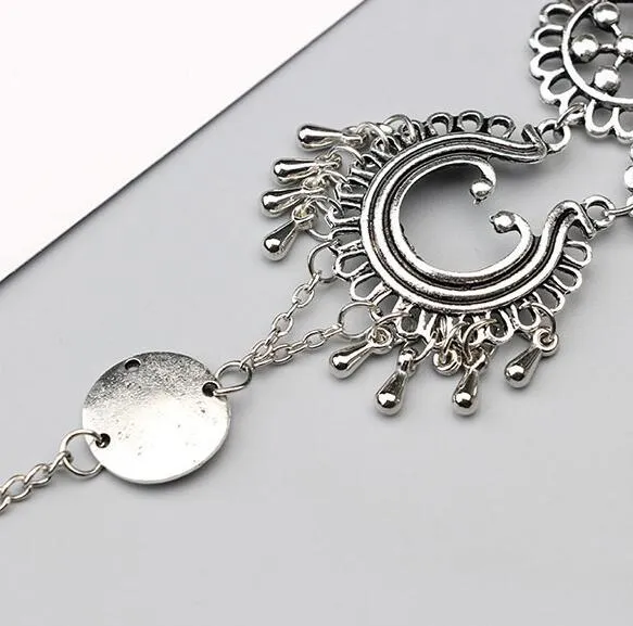 Antique silver hollow flower chain anklet with teardrop shape on a surface, 24cm foot jewellery for women