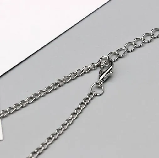 Antique silver hollow flower chain anklet with teardrop shape on a surface, 24cm foot jewellery for women