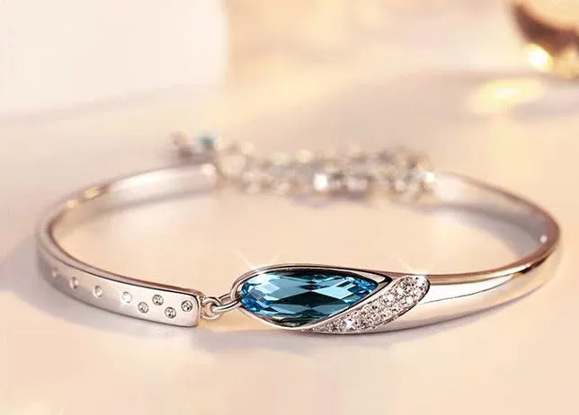 Silver-plated heart pendant necklace with blue crystal zircon inlay on display