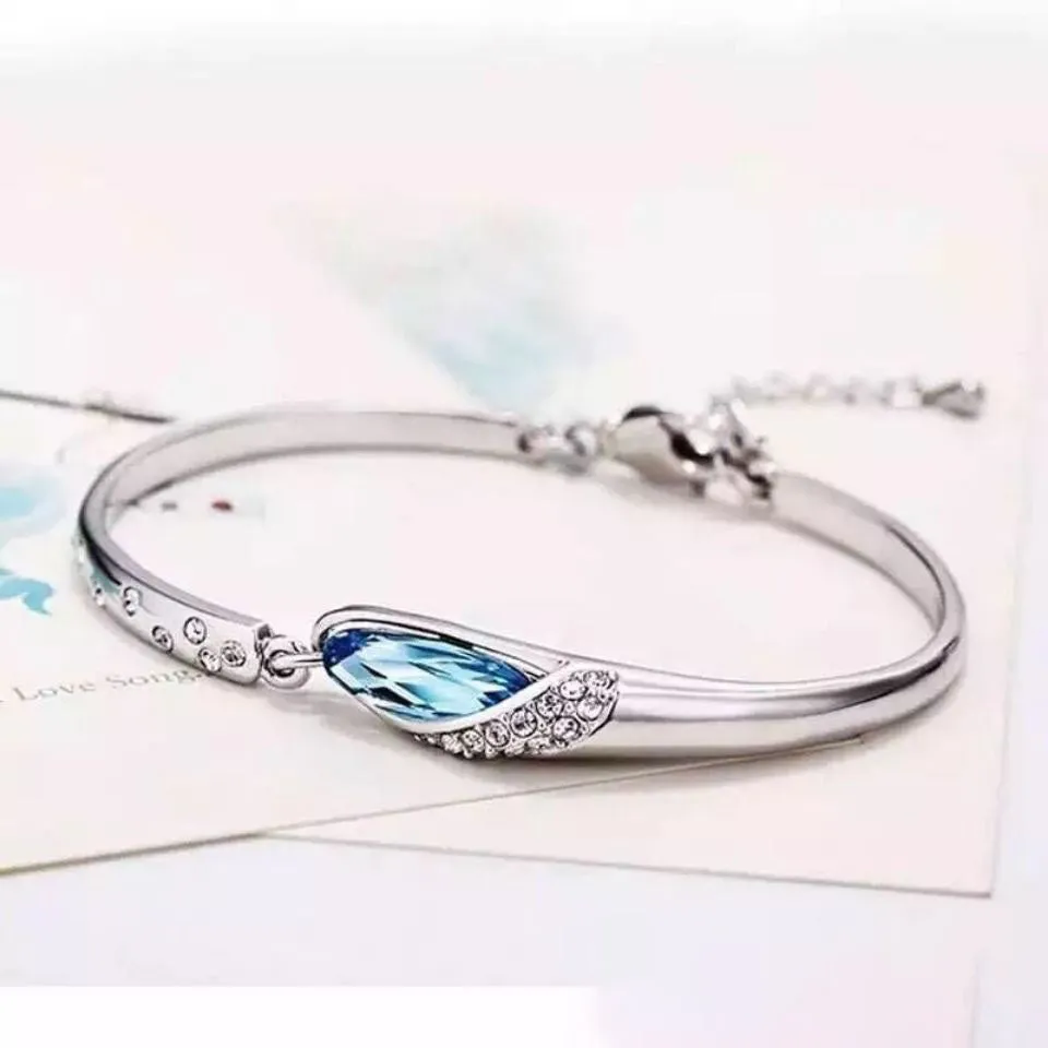 Silver-plated heart pendant necklace with blue crystal zircon inlay on display