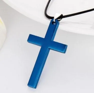 Stainless steel titanium alloy cross pendant on a black whip chain against a dark background